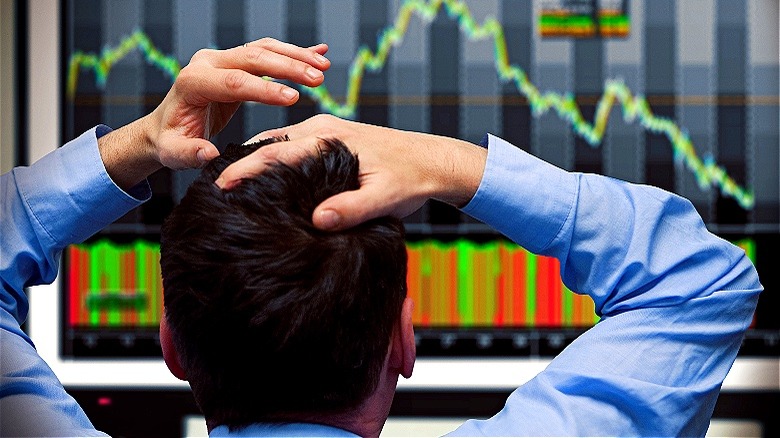 Person watching stock market dip