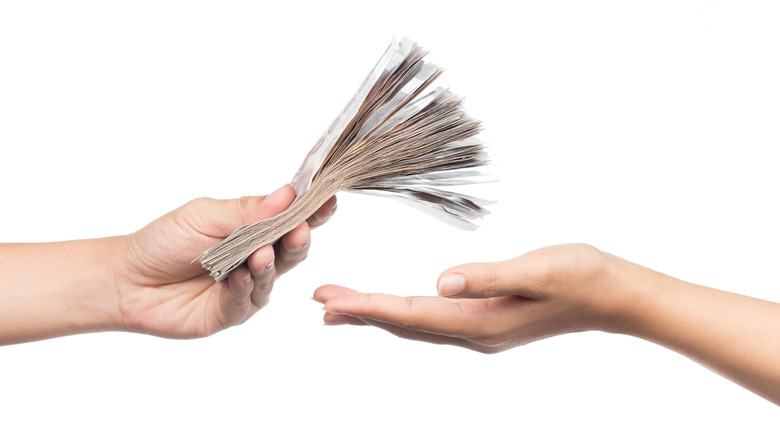 Person handing another person money