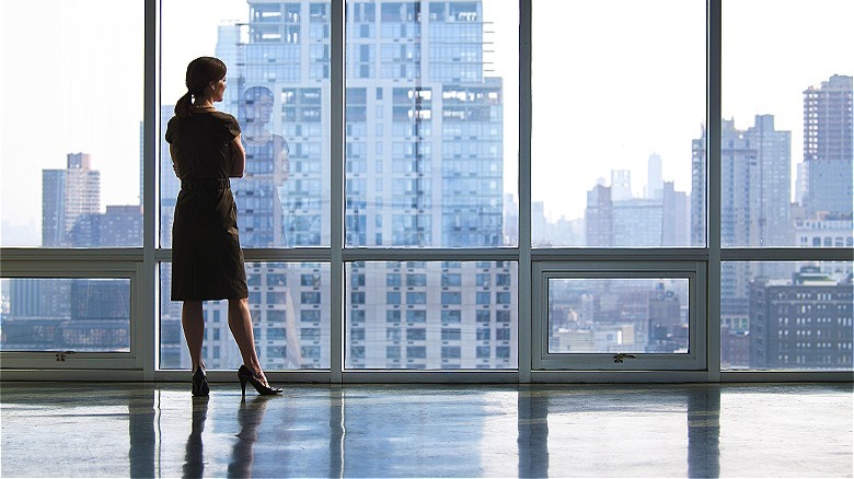 Person looking out window, skyscraper