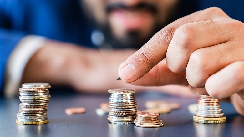 Person creating coin stacks