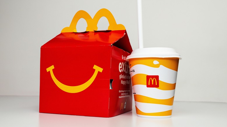 A Happy Meal box and drink from McDonalds