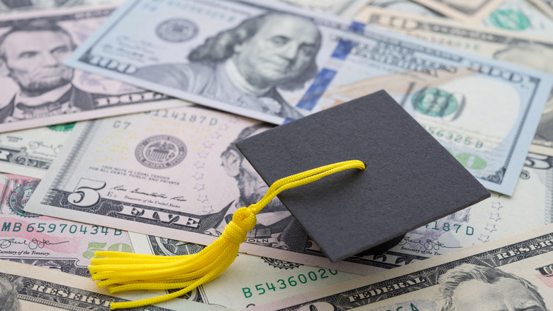 graduation cap on money