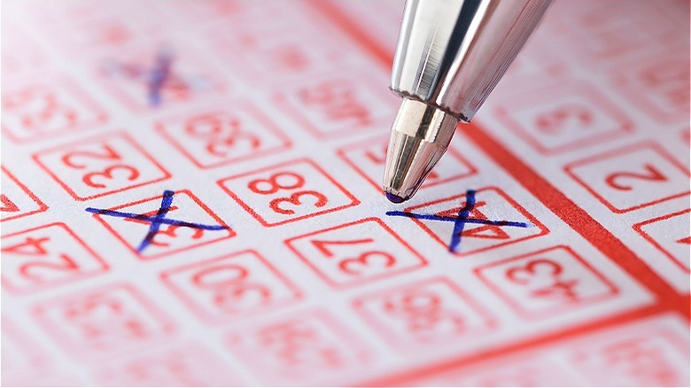 Person filling out lottery ticket