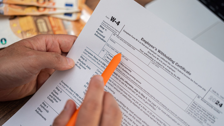 Person completing a W-4 tax form