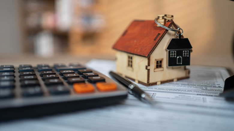 model of a house and a calculator closeup