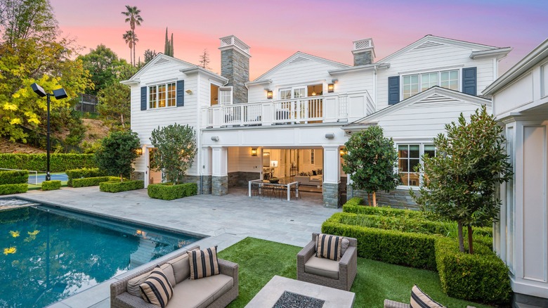 A white mansion with a pool at sunset in southern California