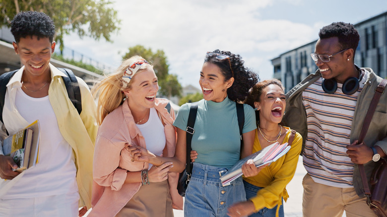 Young adults walking and laughing