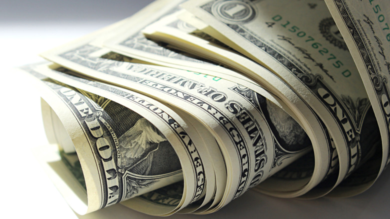 Money rolled together