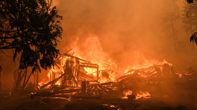 The burning remains of a house engulfed in flames
