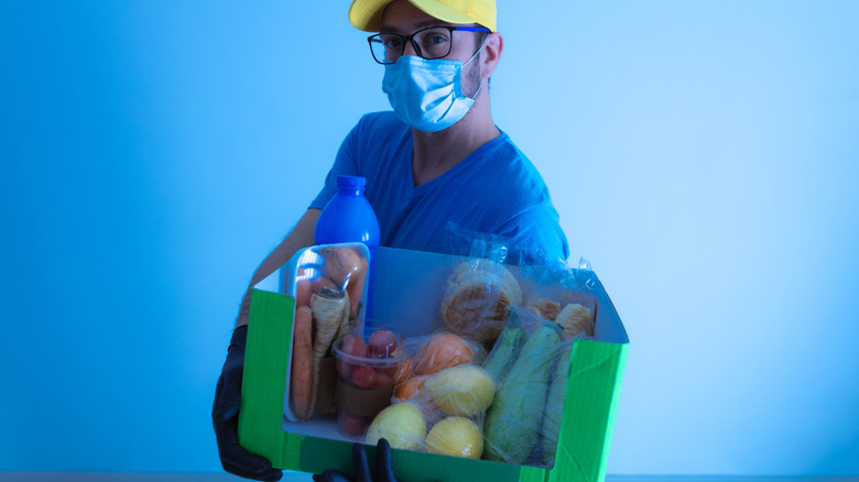 man cayying grocery delivery