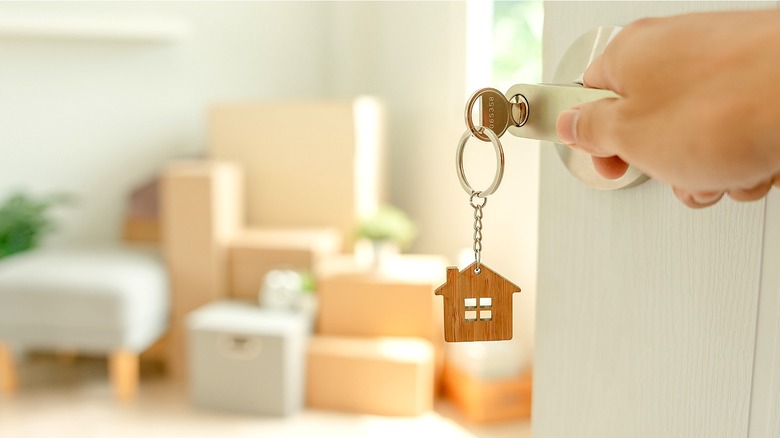 Hand opening door to home