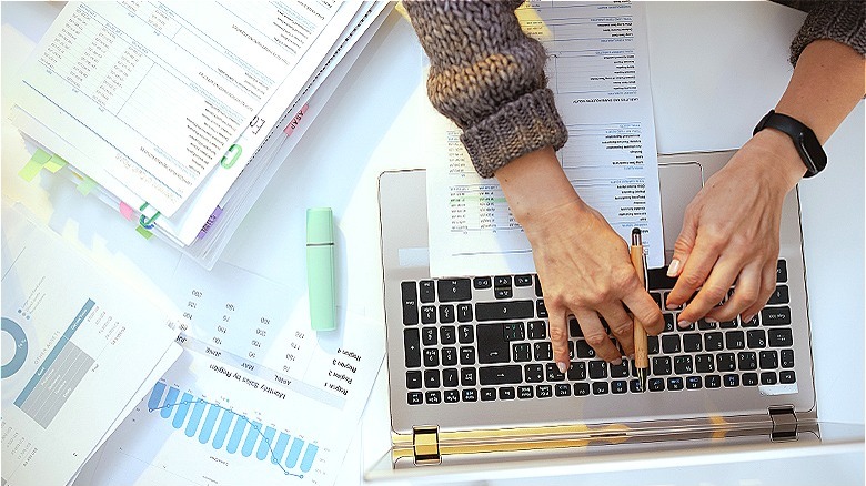 Person handling finances at home