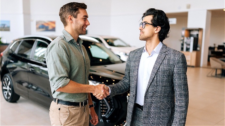 Two people making car transaction