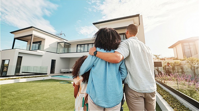 Family gazing at beautiful home