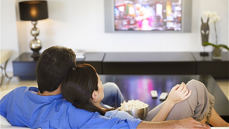 Couple watching TV at home