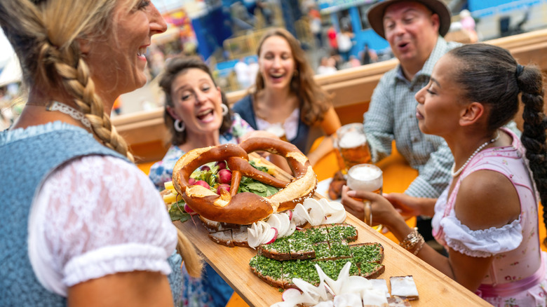 Waitress serving German food to table