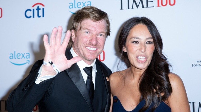 Chip and Joanna Gaines posing together on the red carpet at a media event in 2019.