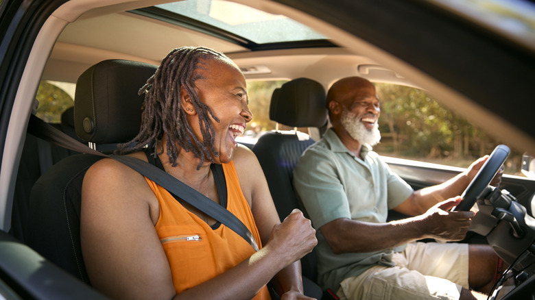 A senior couple in a car