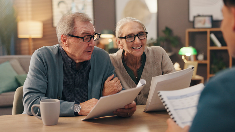 Edlerly couple meets with financial planner.