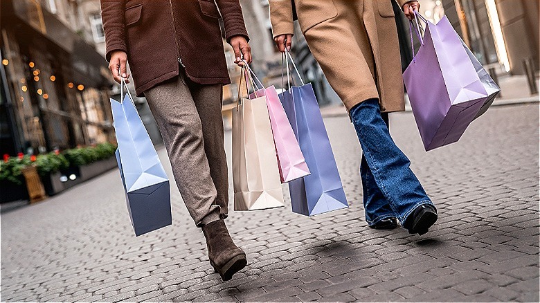 two people with shopping bags