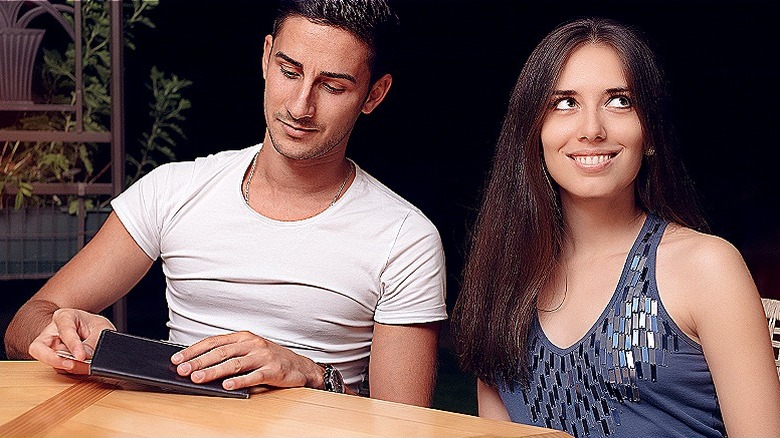 person ignoring restaurant check