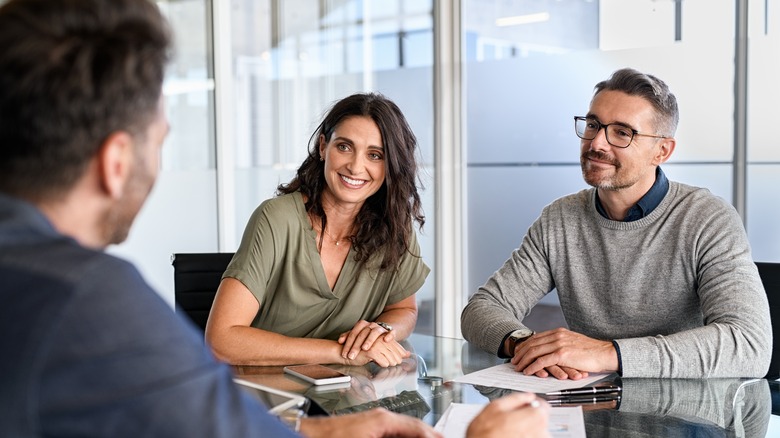 Couple speaking with banker