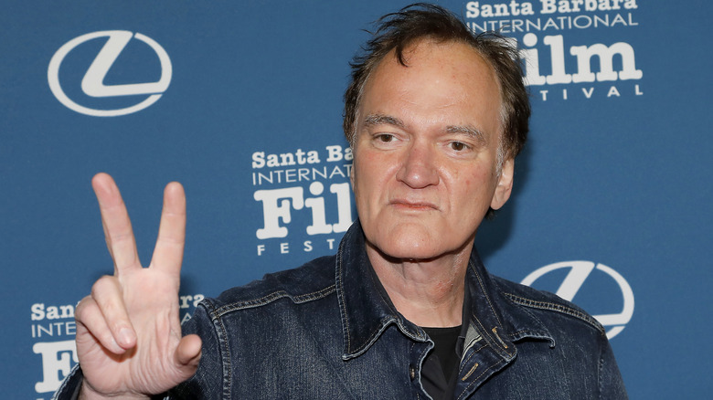 Director Quentin Tarantino making a peace sign with his fingers at the Santa Barbara International Film Festival.