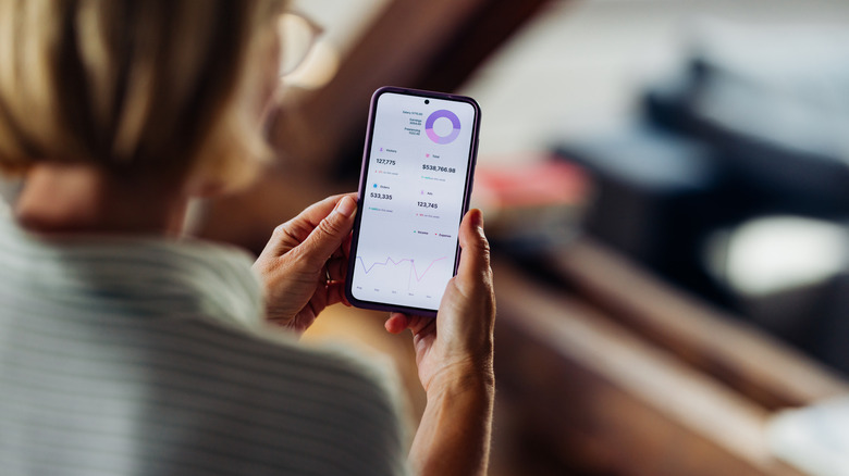 Woman checking investments on a smartphone