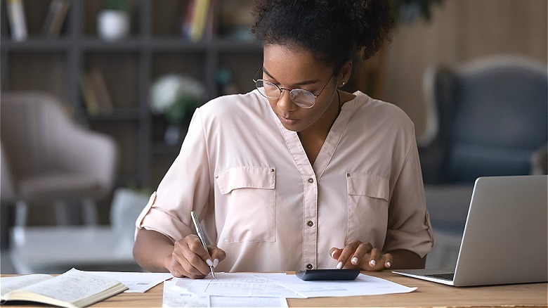 Person making calculations at table