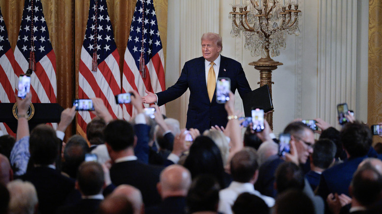 Trump in White House, being photographed via many phones at Republican reception for One Big Beautiful Bill