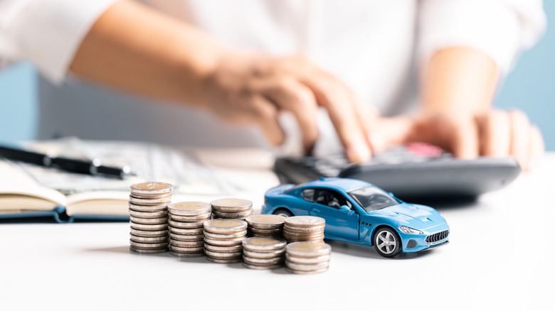 Stacks of coins next to small model car