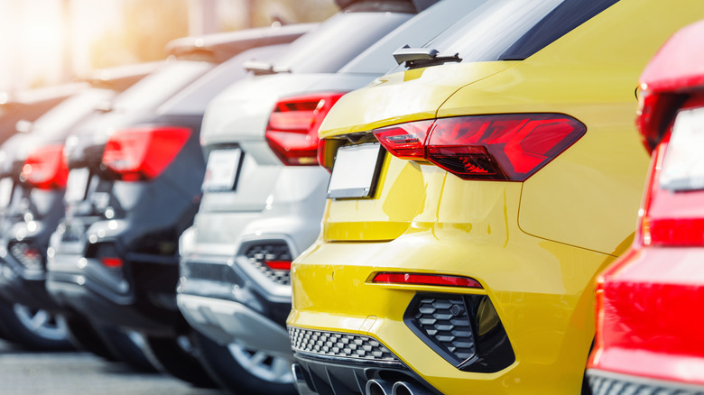 A row of new cars parked in a line