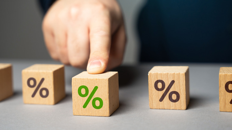 person pushing forward a percentage block