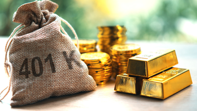 Bag with 401k written on it next to a pile of gold bars and coins