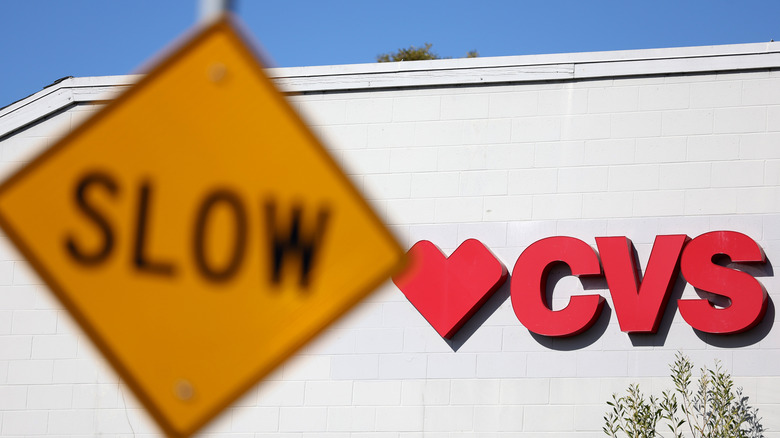 A sign is posted on the exterior of a CVS Pharmacy in Half Moon Bay, California
