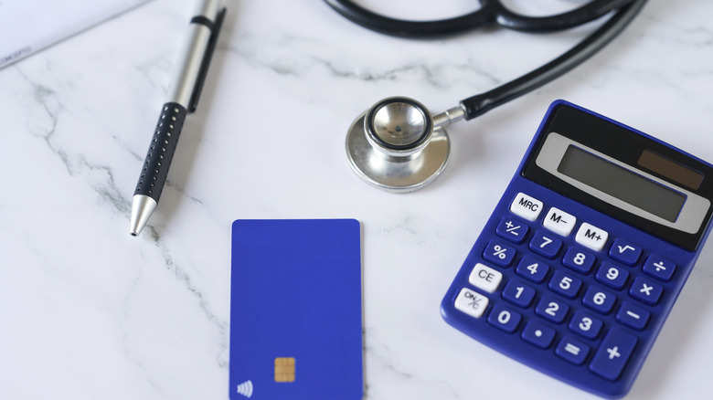 Blue credit card next to stenoscope and calculator