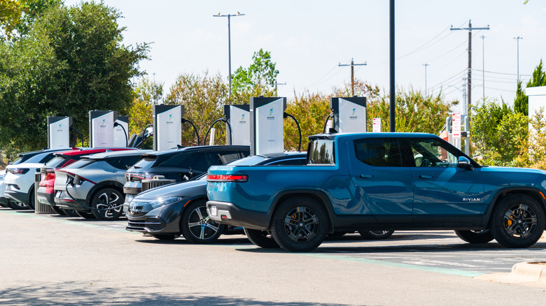 A row of electric cars charging