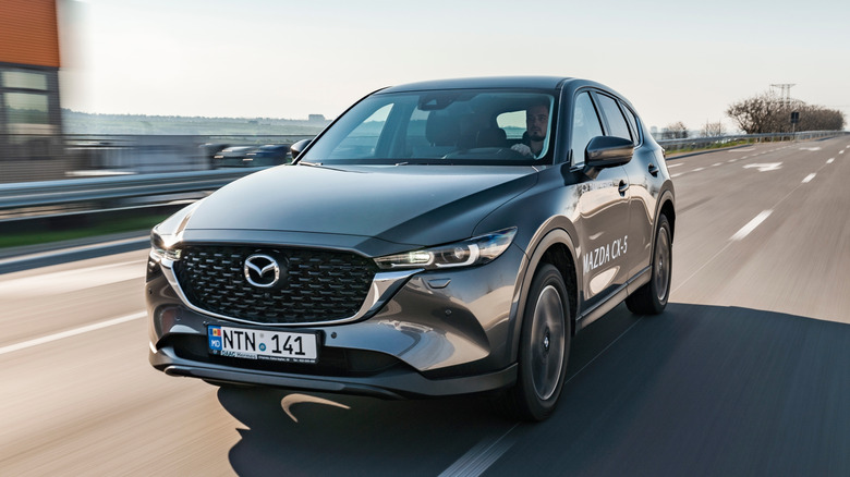 A grey Mazda CX-5 driving on highway