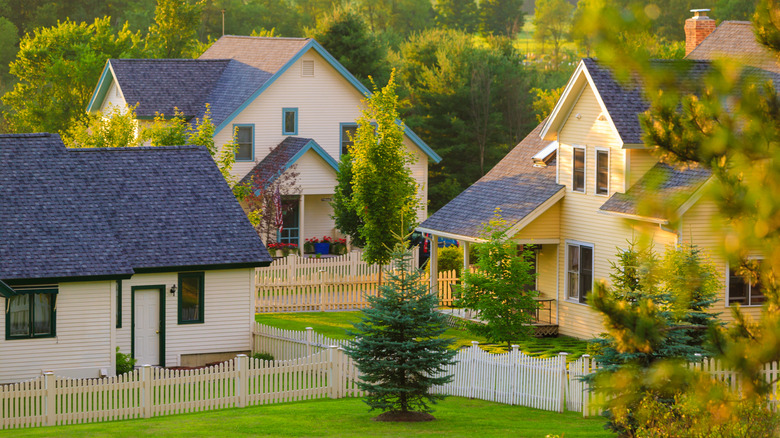 Three homes with white picket fences in Stowe Vermont, USA