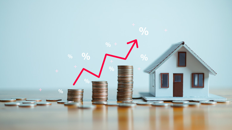 Up arrow showcasing stacks fo coins and a home.