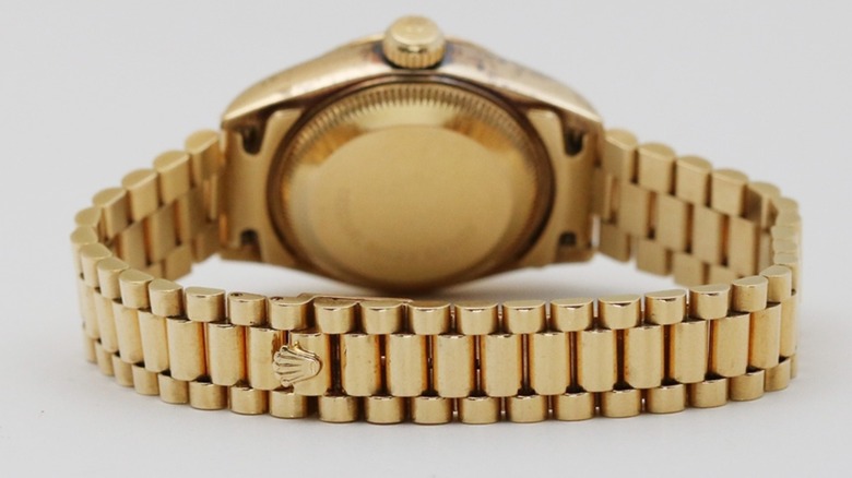 The back of a Rolex Lady-Datejust against a gray background