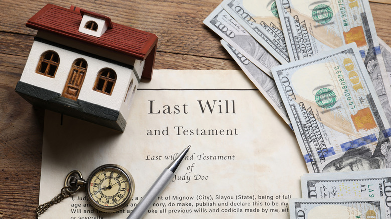 Will and testament paperwork surrounded by hundred dollar bills.