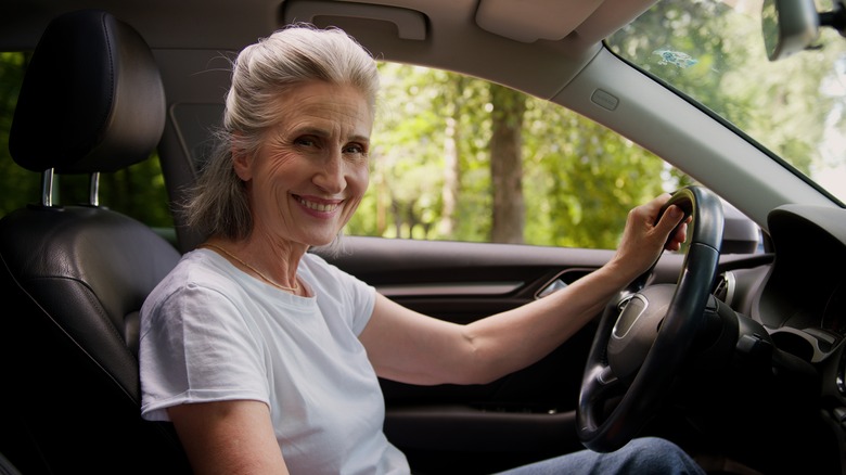 Gray-haired woman behind the wheel of a car