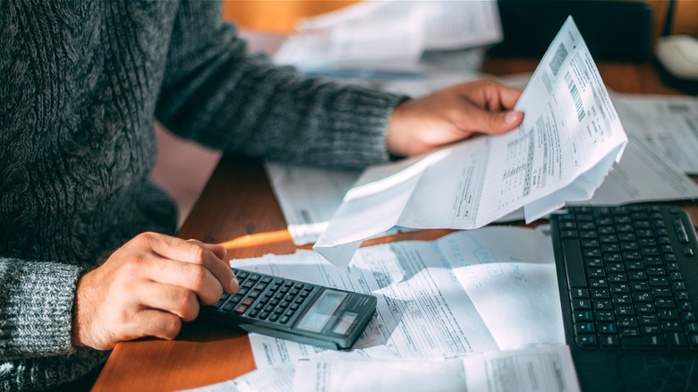 Person making calculations from paperwork
