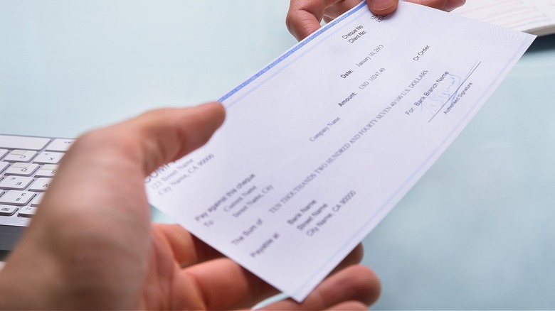 Person handing over cashier's check