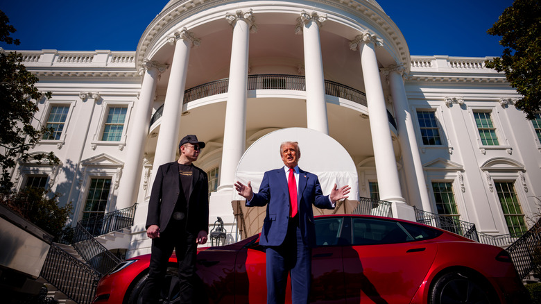 Elon Musk and Trump in front of a red tesla