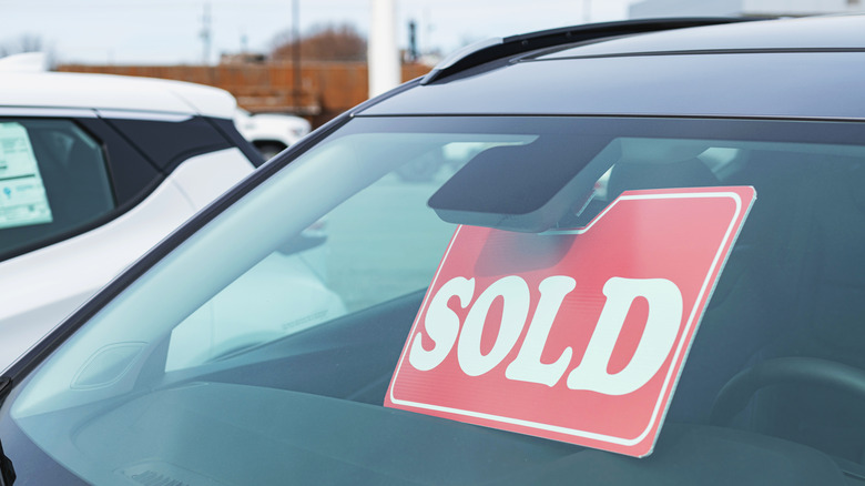 Sold sign on a car windshield