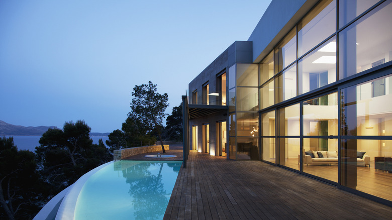 A mansion with an outdoor pool at night