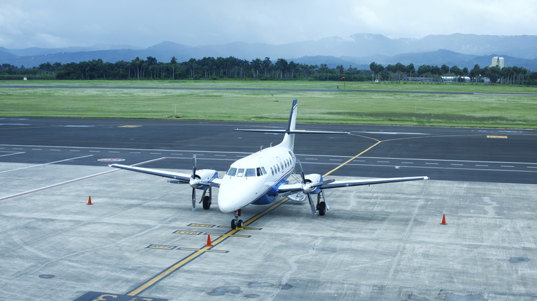 A twin engine plane parked on the tarmac