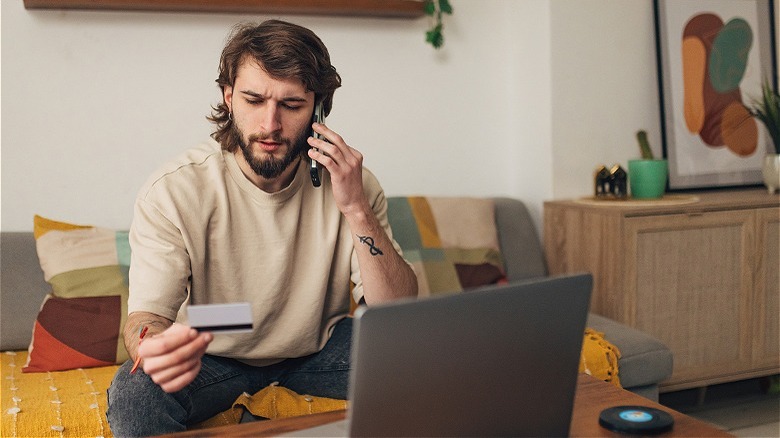 Person on phone with card